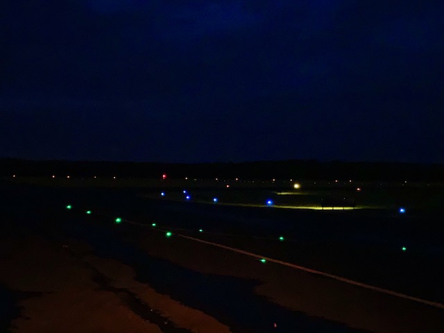 Green And Blue Light Highlights The Edge Of Runway